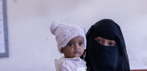 Married at 12, Yousra, 16, holds one of her two daughters in Taizz, Yemen. 